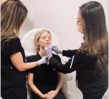 Medical Aestheticians examining woman's face
